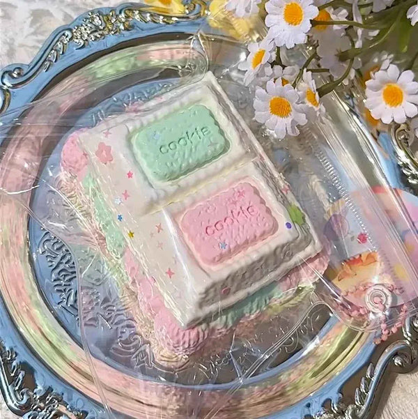 Pastel-colored cookie-shaped squishy package with green and pink cookies labeled "cookie", from Lovesquishy's Food Series.