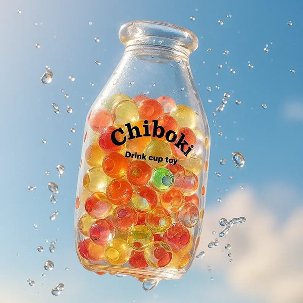Clear glass bottle filled with colorful orange, yellow, green balls, labeled Chiboki Drink cup toy, with water droplets, part of Bottle Series.
