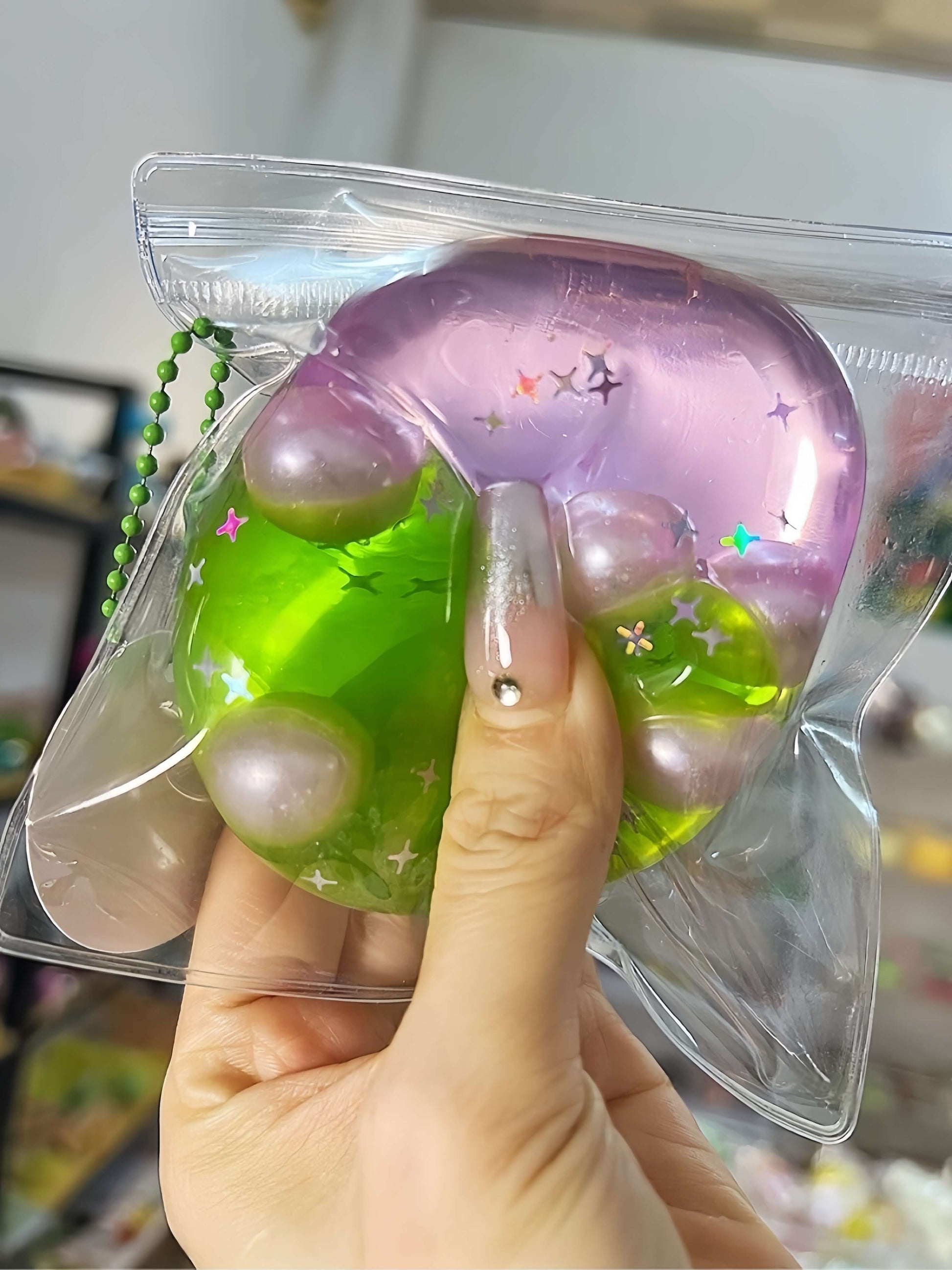Non-toxic handmade layered dual-color stress relief ball with Barbie pink and green grape layers, flowing sand texture