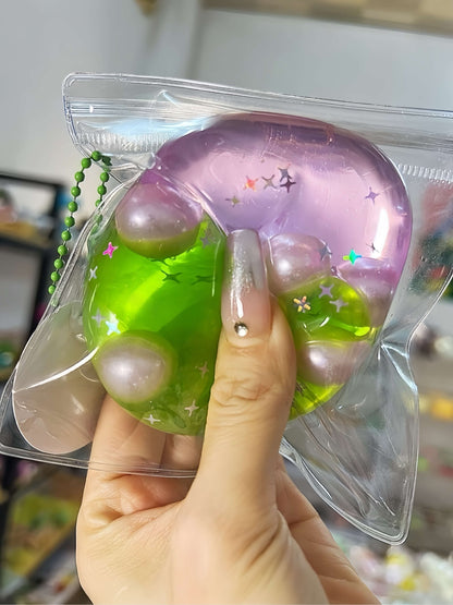 Non-toxic handmade layered dual-color stress relief ball with Barbie pink and green grape layers, flowing sand texture