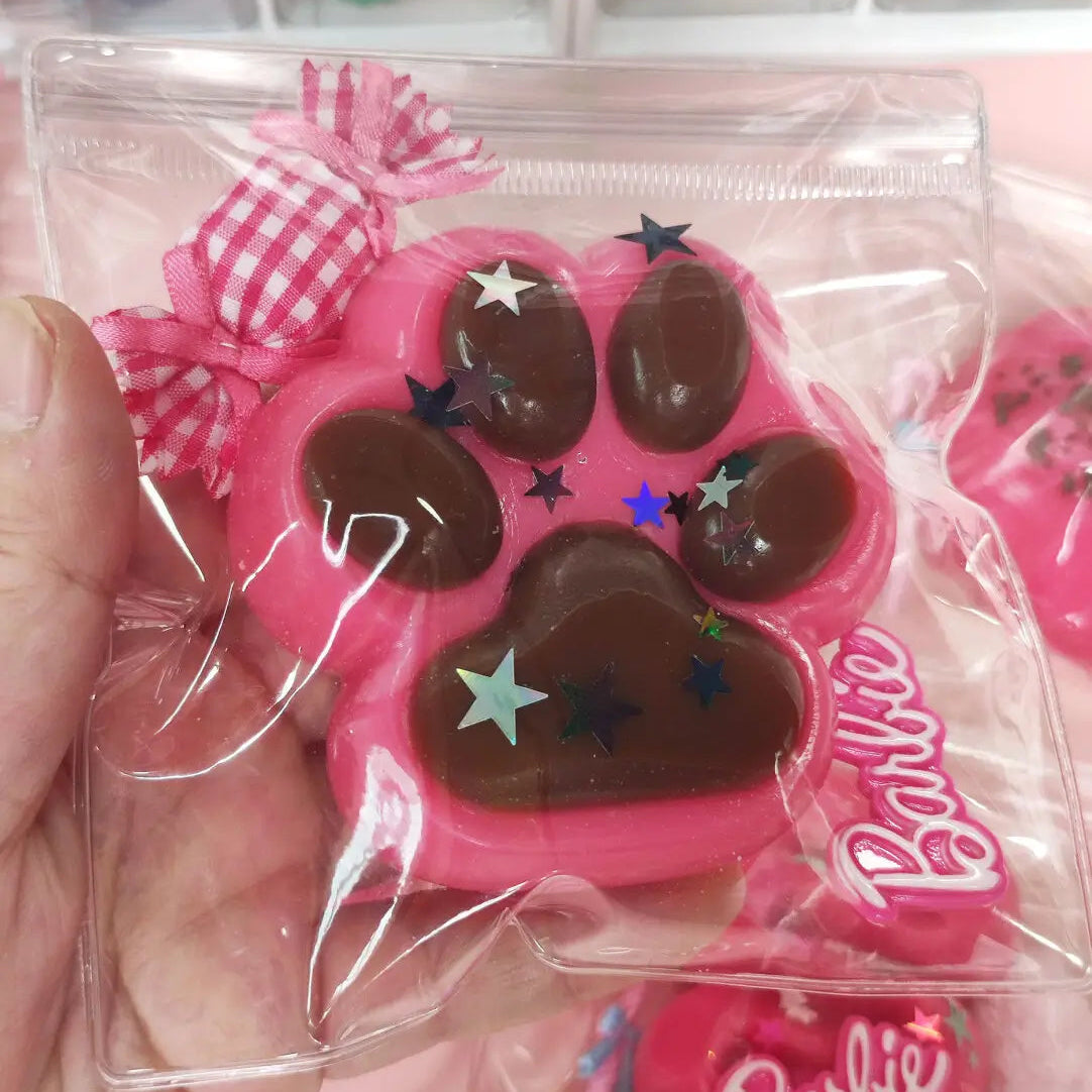 Lovesquishy pink cat paw squishy with brown pads and star decorations