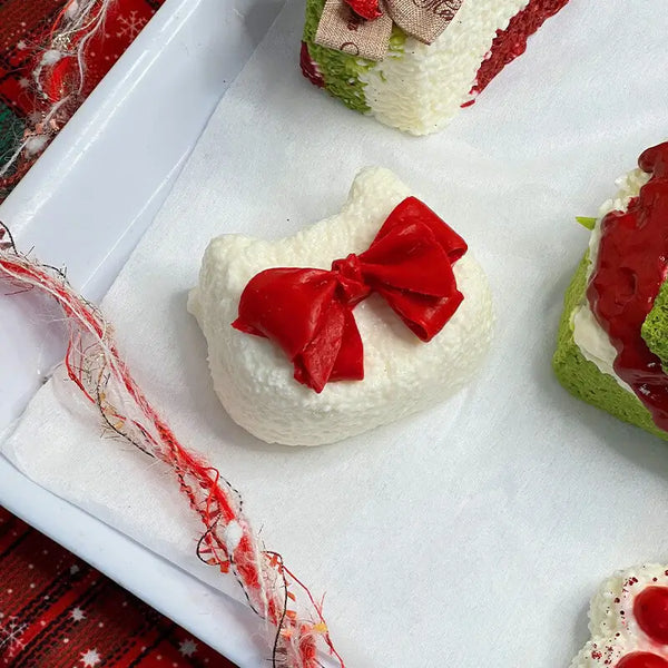 Bowknot cake squishy with red bow; soft holiday stress relief toy from lovesquishy