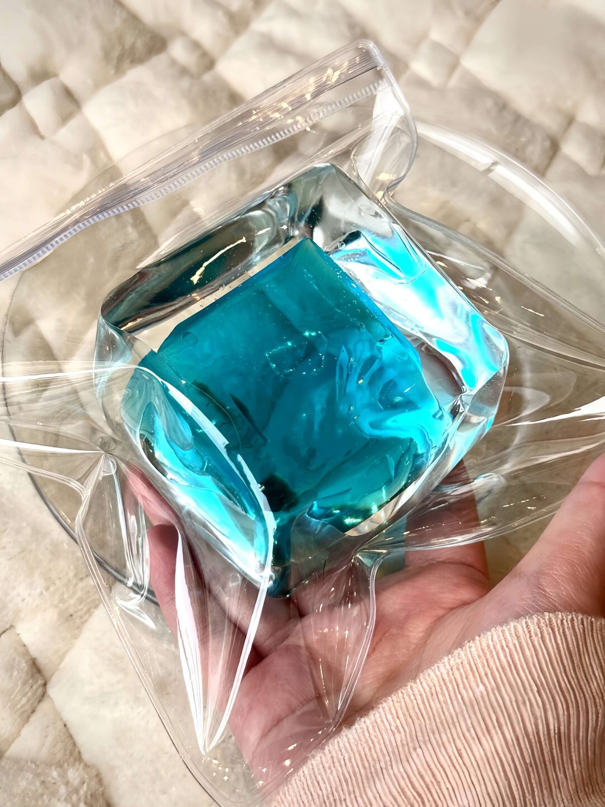 Clear bag holding blue ultra-soft ice block toy from lovesquishy