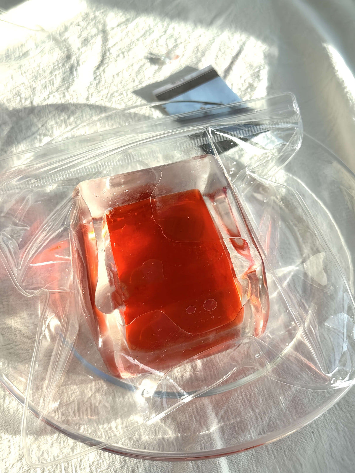 Blood orange flowing sand ice block in clear packaging - ultra soft squishy toy by lovesquishy