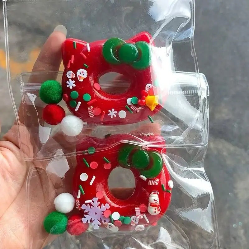Red Hello Kitty squishy toys with green bows, festive decorations, packaged in clear plastic – lovesquishy holiday collection