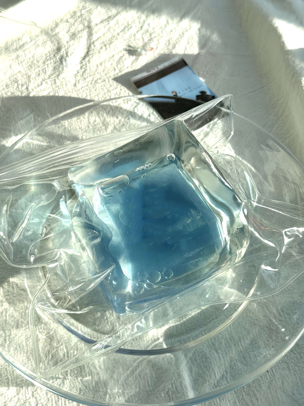 Clear container with blue flowing sand ice block toy at lovesquishy