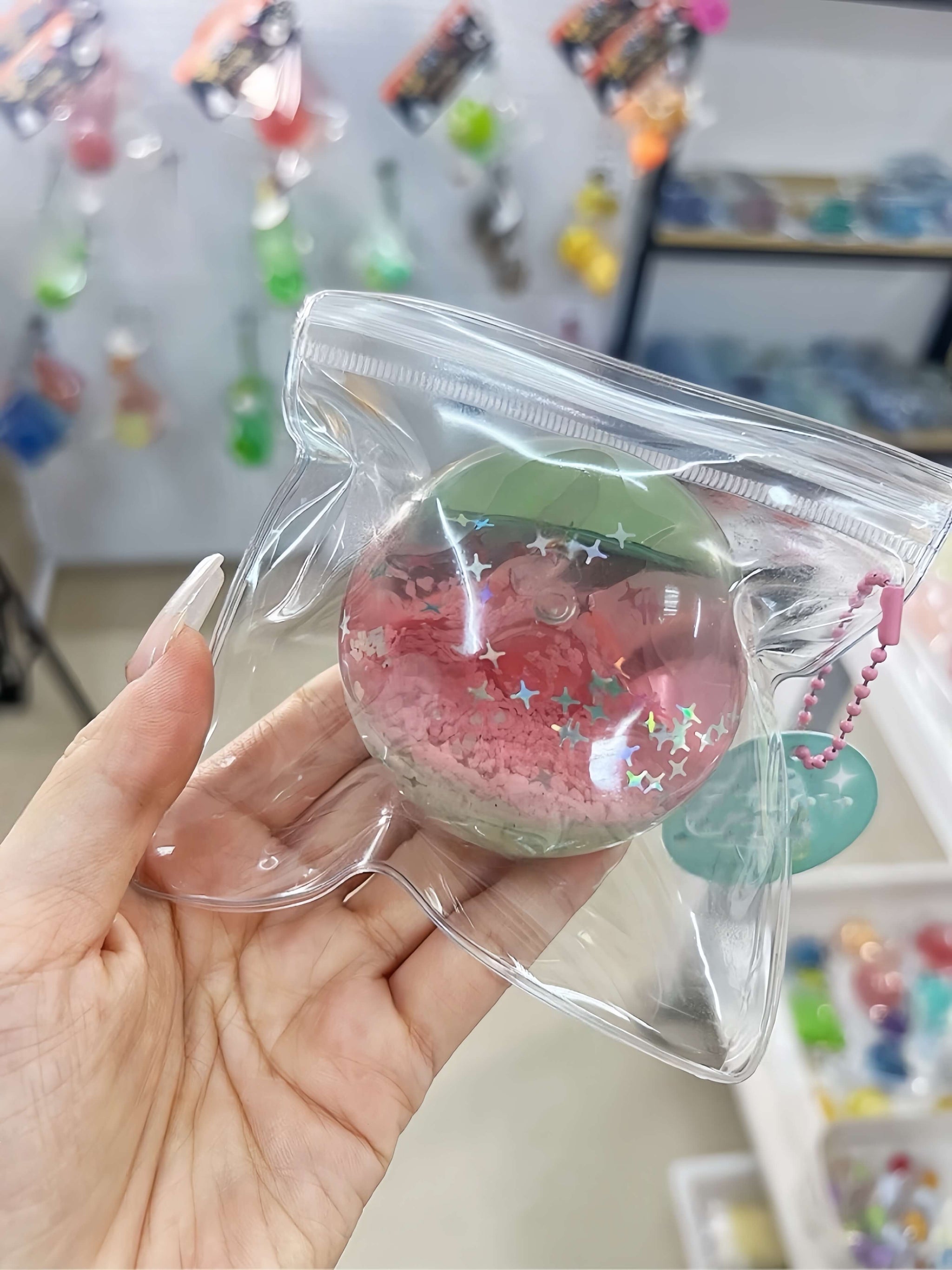 Non-toxic handmade layered dual-color stress relief ball with mint pink glow sea sand layers, flowing sand texture