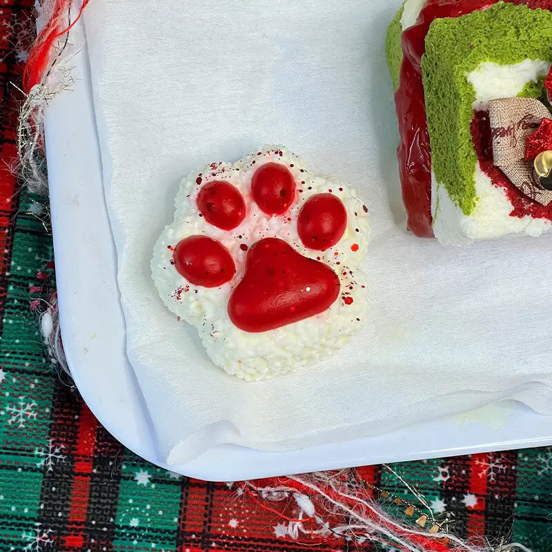 Red paw onigiri squishy with cherry details; soft holiday stress relief toy from lovesquishy