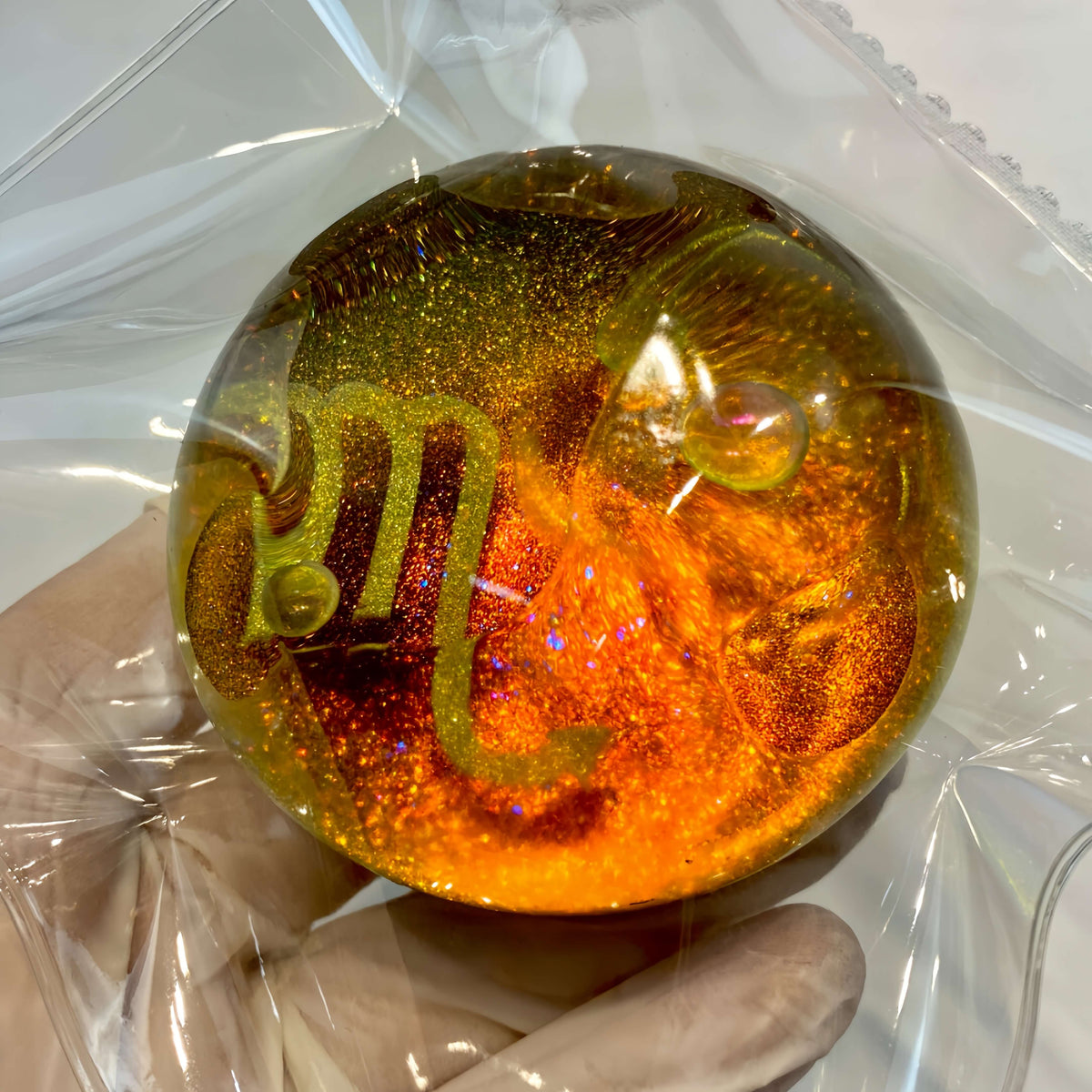 Clear silicone Scorpio galaxy orb with gilded nebula design from lovesquishy