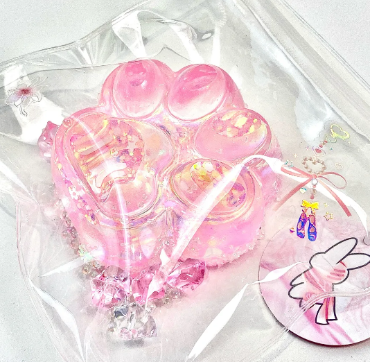 Dreamy pink cat paw transparent silicone squishy toy in clear packaging