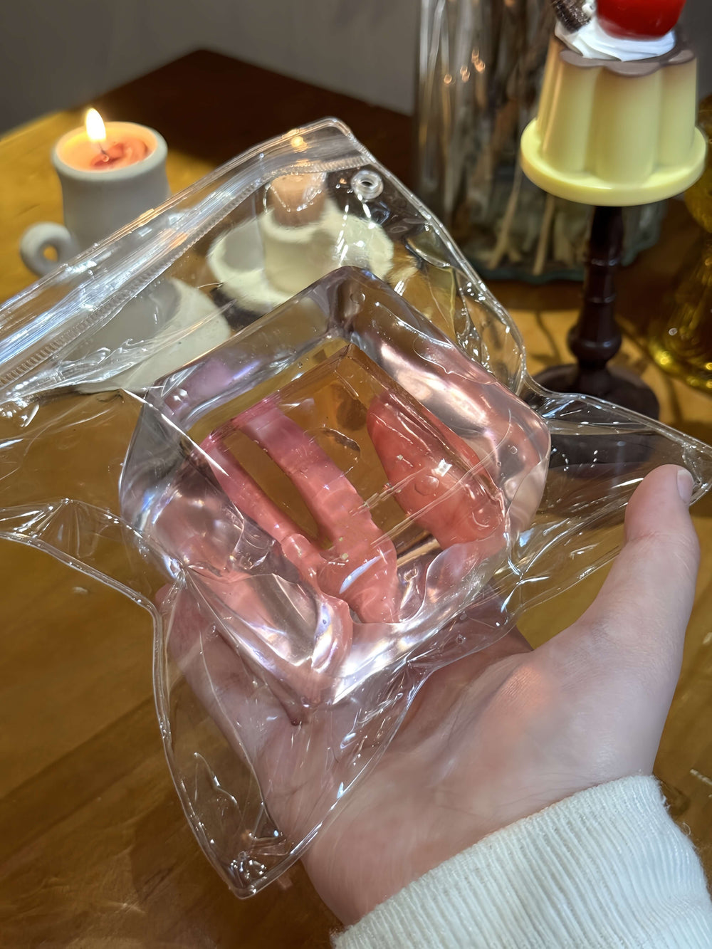 Tipsy peach-colored soft ice block in clear packaging