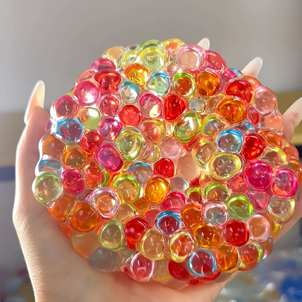 Handmade colorful pearl squishy ball for stress relief, held in hand