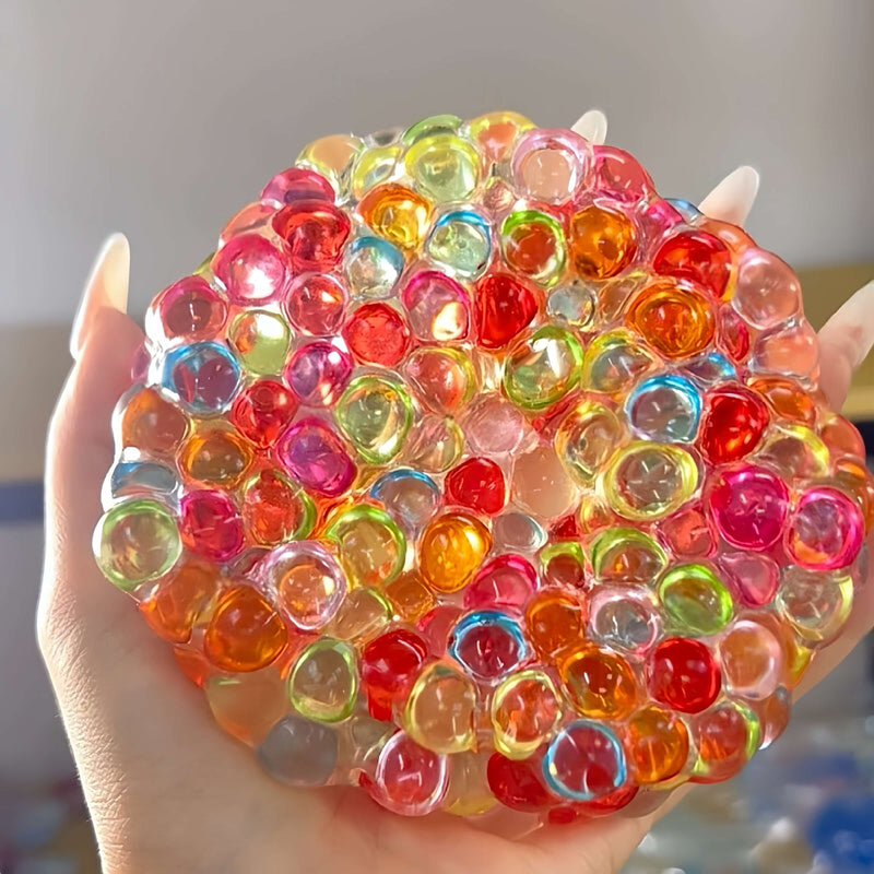 Handmade colorful pearl squishy ball for stress relief, held in hand